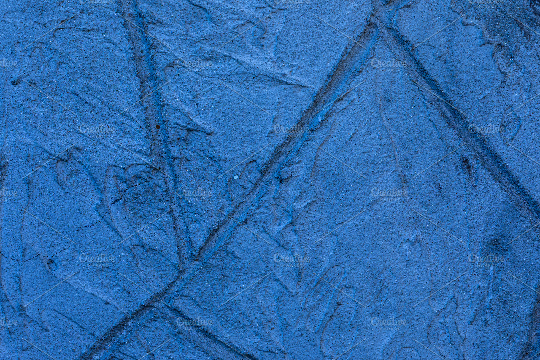 Close-up of a blue textured plaster wall with subtle cracks and, a Background Photo by Ales Munt