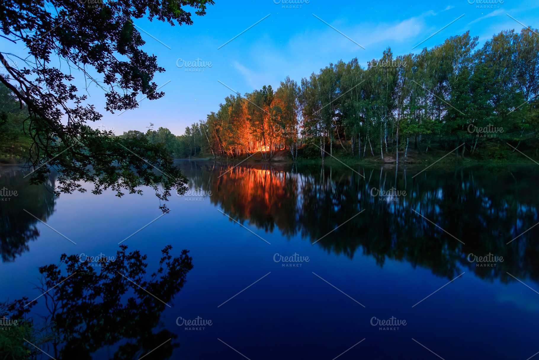 Night landscape with bonfire reflection on water surface, blue s, a Nature Photo by Eugene_Photo