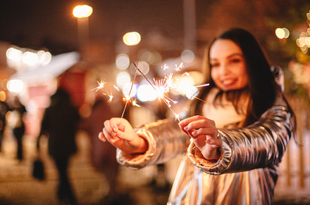 Young woman holding sparklers, a Holiday Photo by finwal89