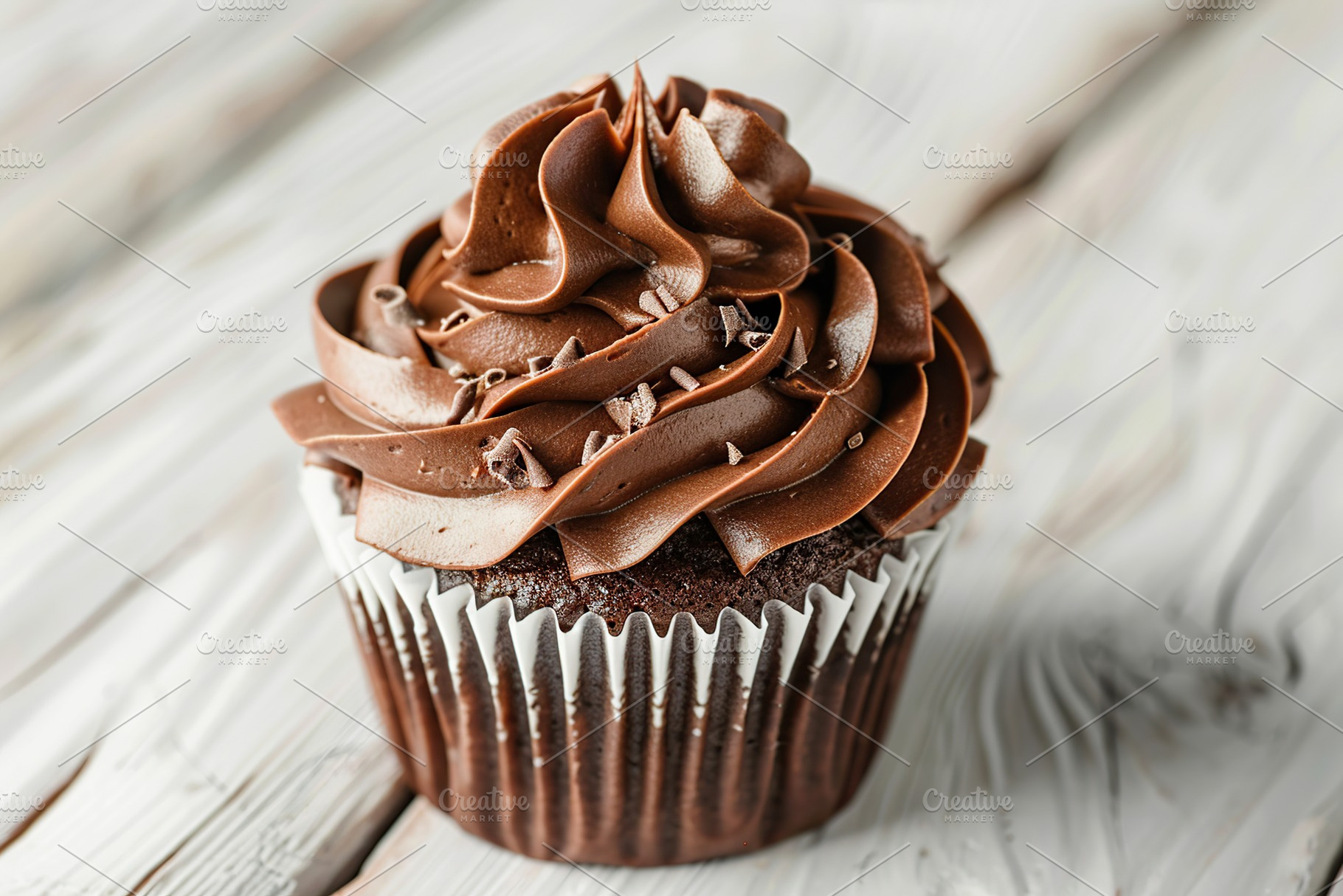 Chocolate cupcake with whipped cream on wooden table, a Food & Drink Photo by AlyaAnd