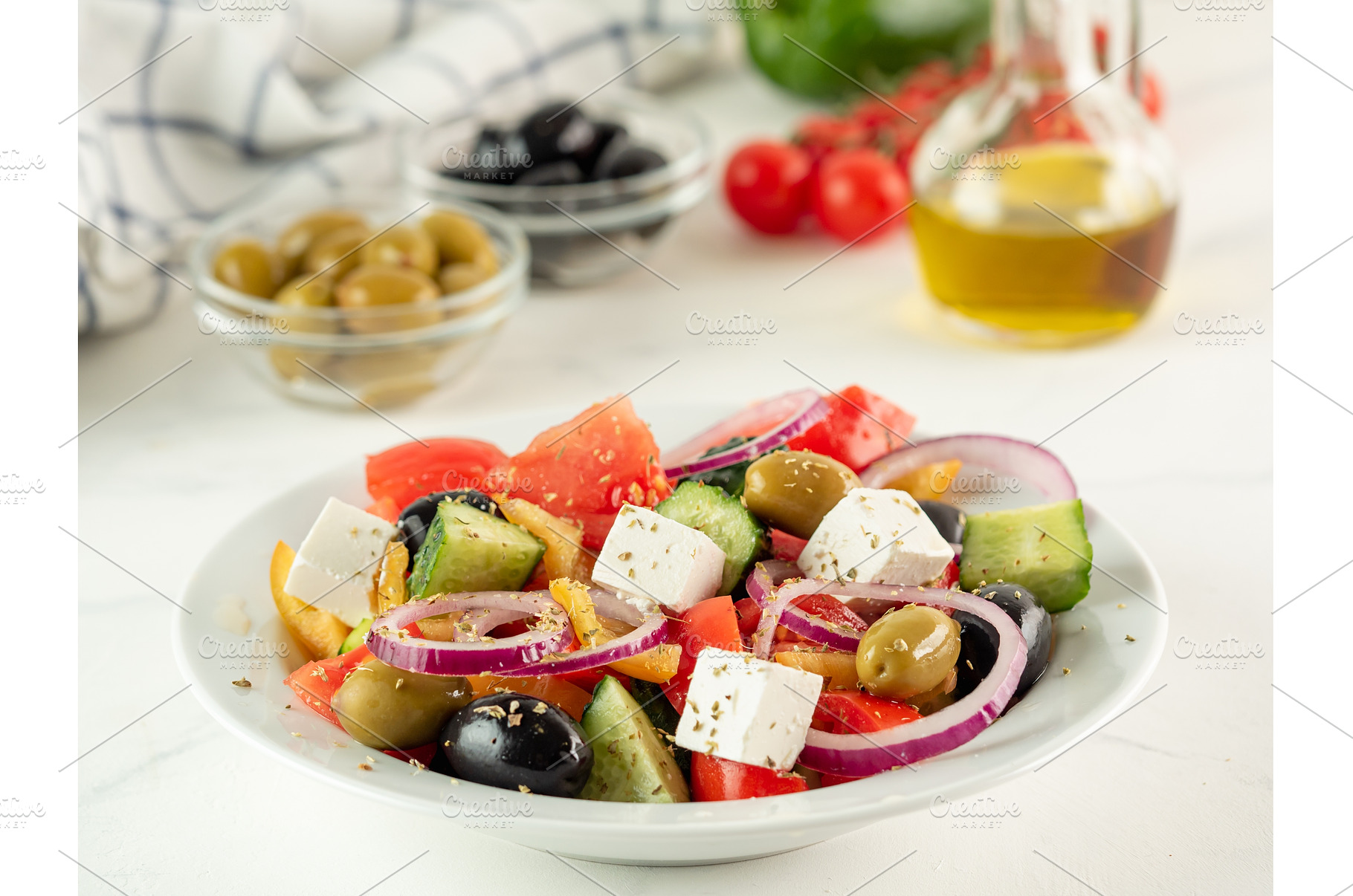 Greek salad on white table, a Food & Drink Photo by Fascinadora