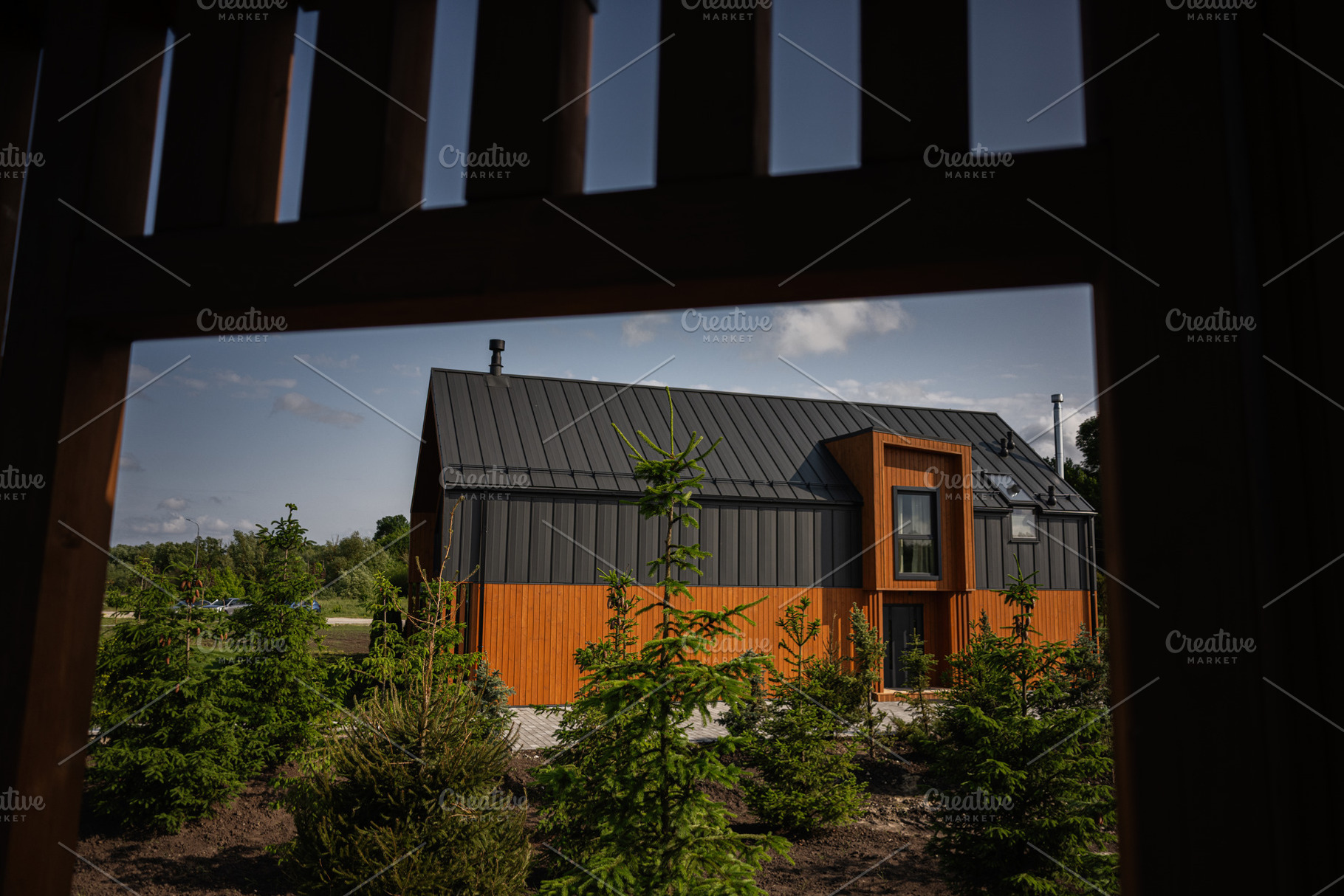 Modern wooden and metal house surrounded by greenery framed by nearby wooden st, a Photo by AS photostudio