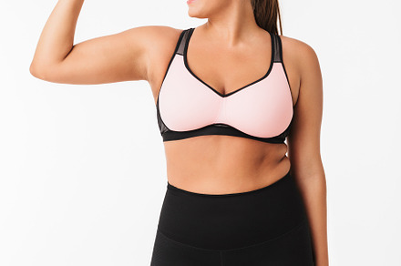 Smiling plump girl in sporty top and containing half face, positive, and