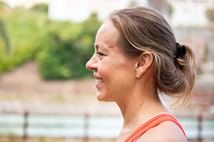 Side profile portrait of smiling mature woman during outdoor workout, a Person Photo by etorres69