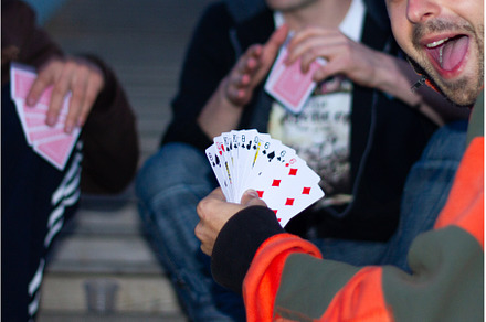 boys playing cards on the steps