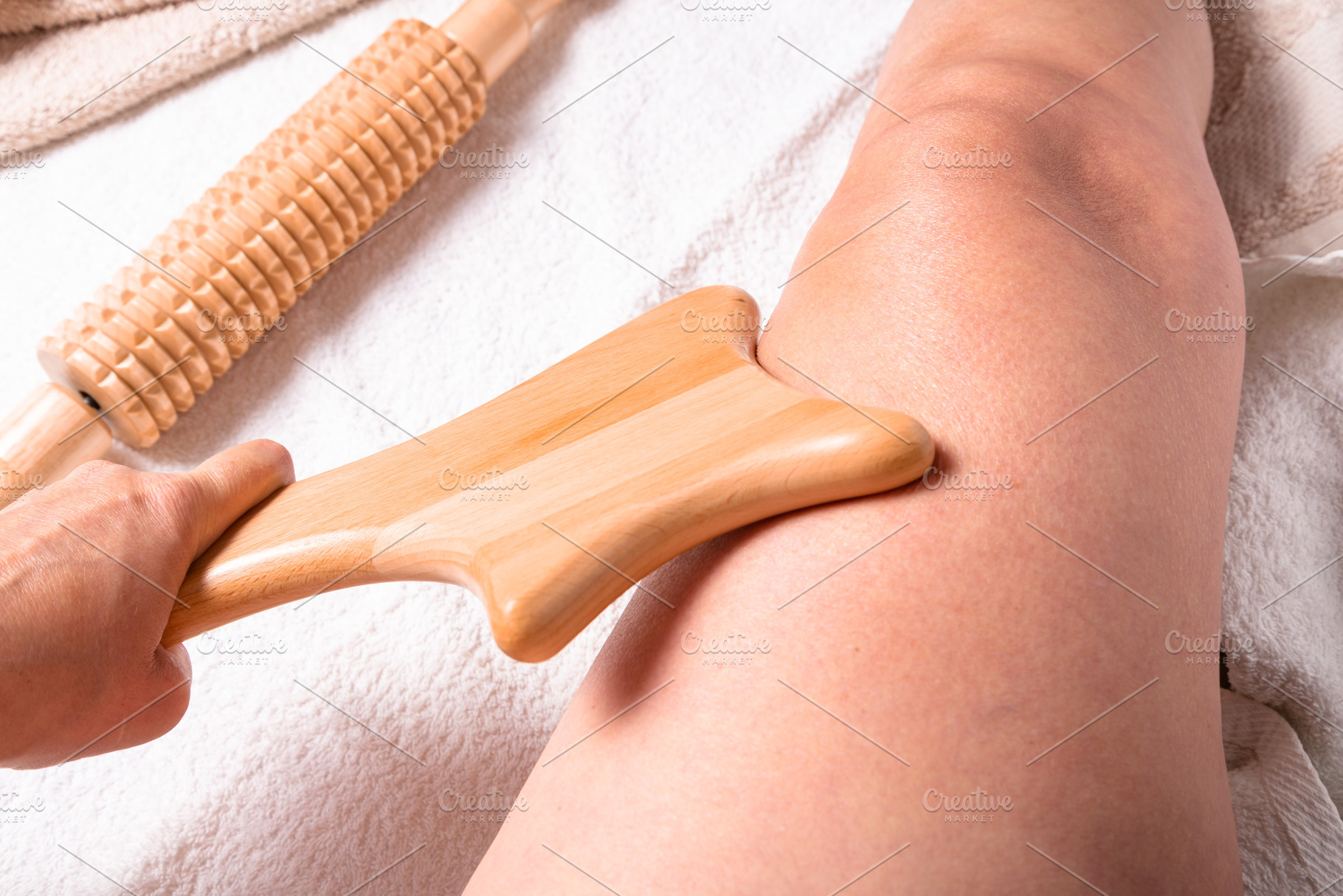 Maderotherapy session. Wooden massage tool in therapist’s hand, a Food & Drink Photo by MDBildes