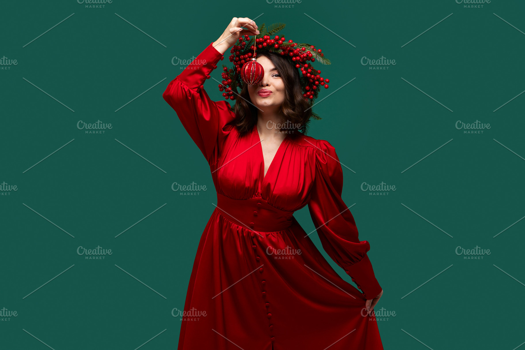 Playful woman holding Christmas ball, a Holiday Photo by Elena Vagengeim