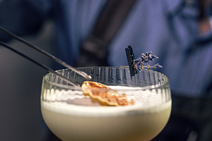 Bartender garnishing cocktail, a Photo by Grafvision photography