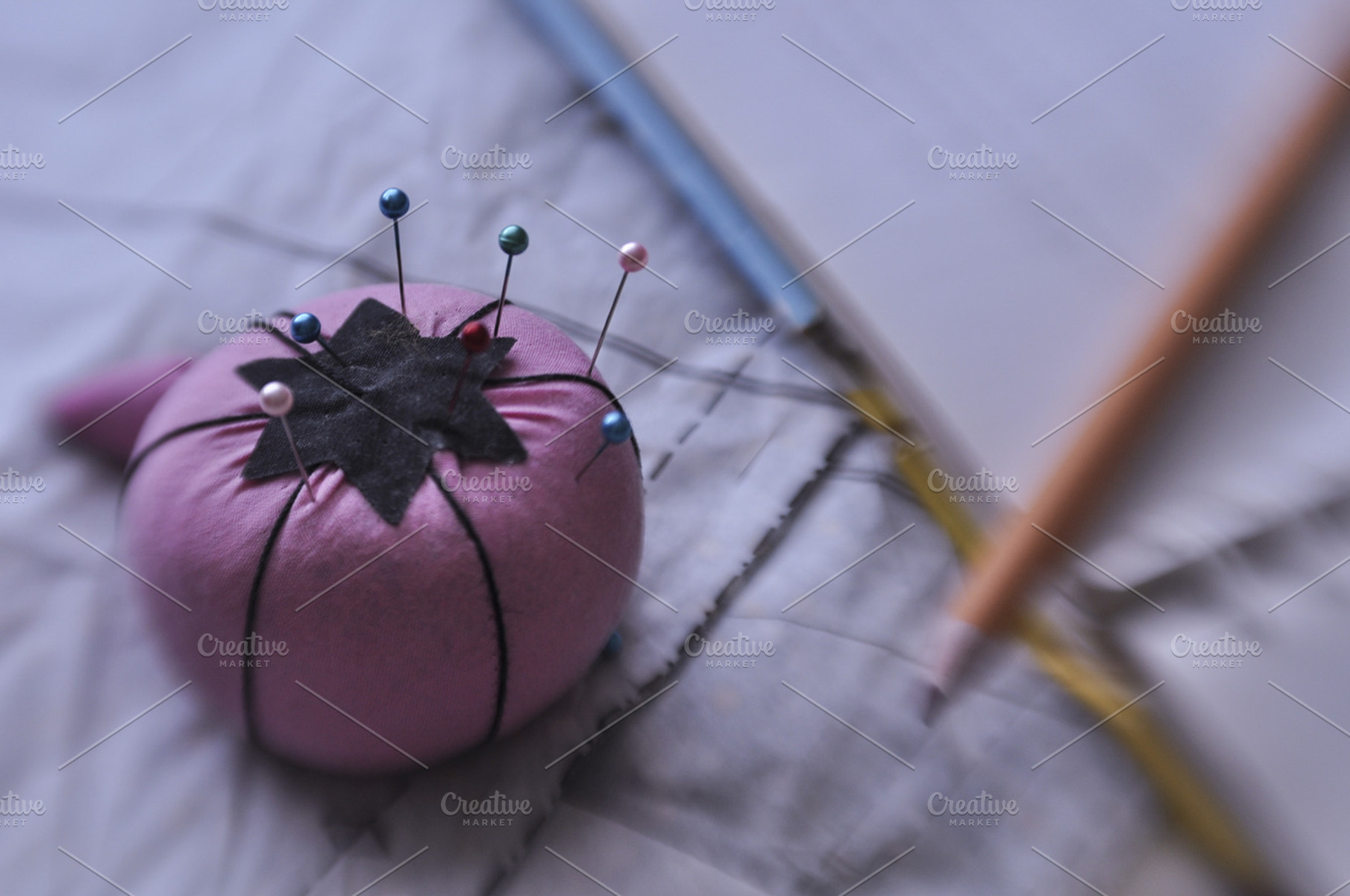 Sewing materials featuring pin cushion, sew, and thread