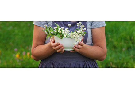 A woman in the garden collects