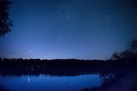 night sky with many stars on a lake, a Nature Photo by Vapi
