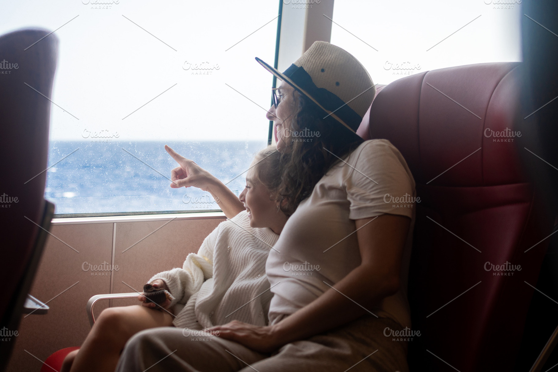 Mother and daughter pointing at sea during ferry journey, a Person Photo by etorres69