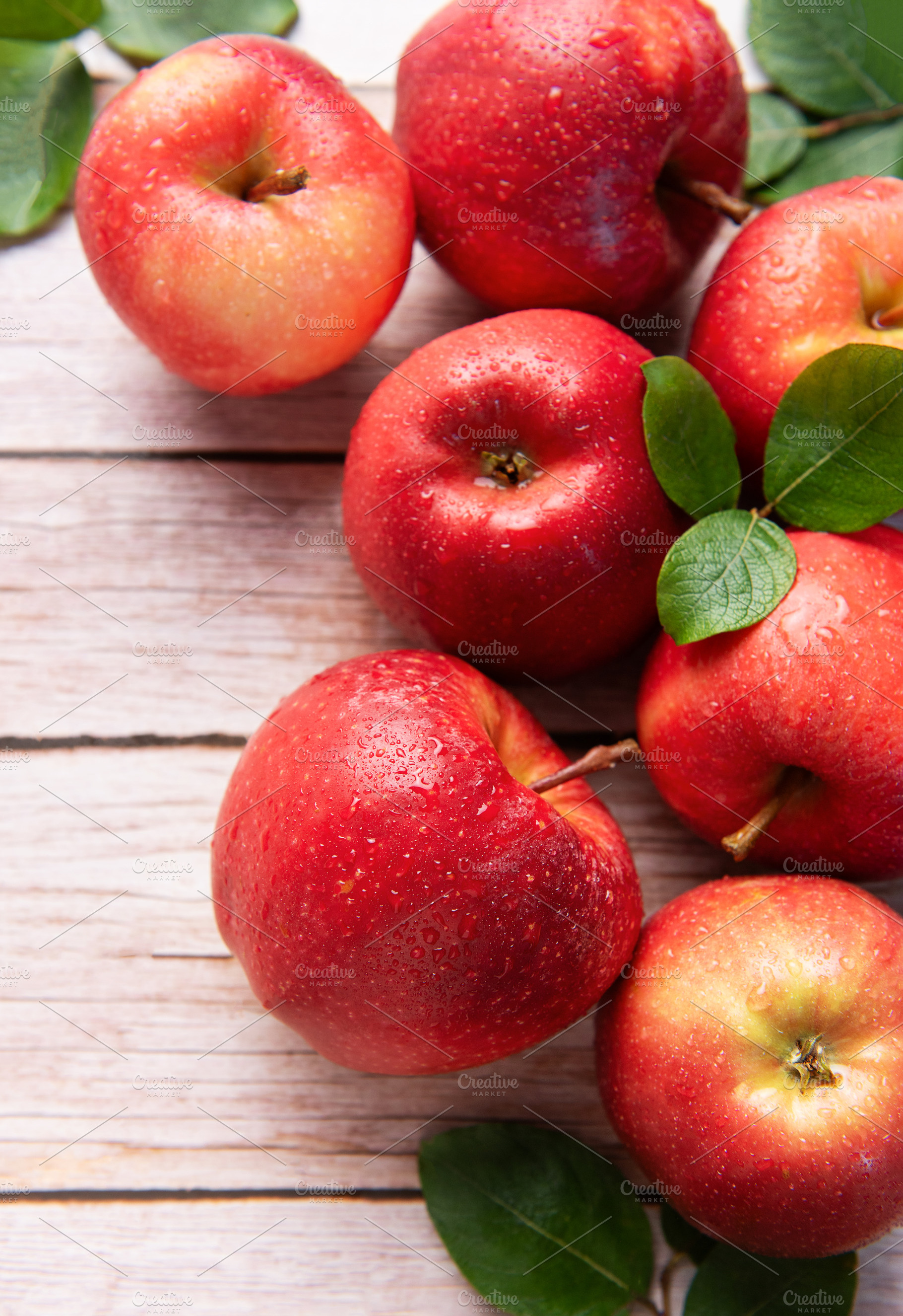 Fresh red apples resting on rustic wooden table, a Food & Drink Photo by Olena Rudo