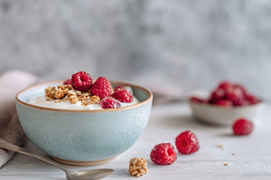 A bowl of yogurt sits on a table, a Photo by Beautiful things