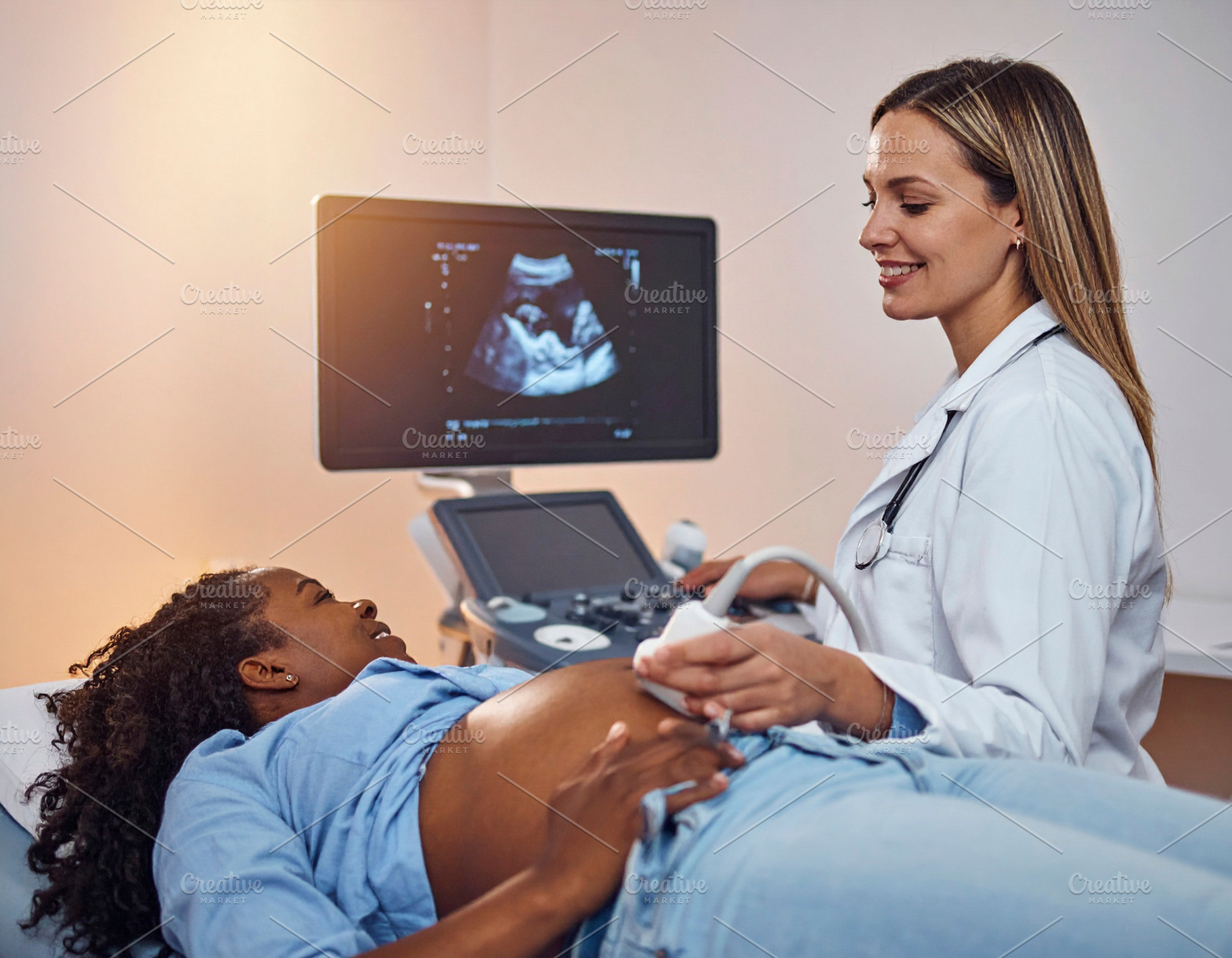Pregnant black woman in a medical room getting an abdominal ultr, a Health & Medical Photo by DanFLCreativo