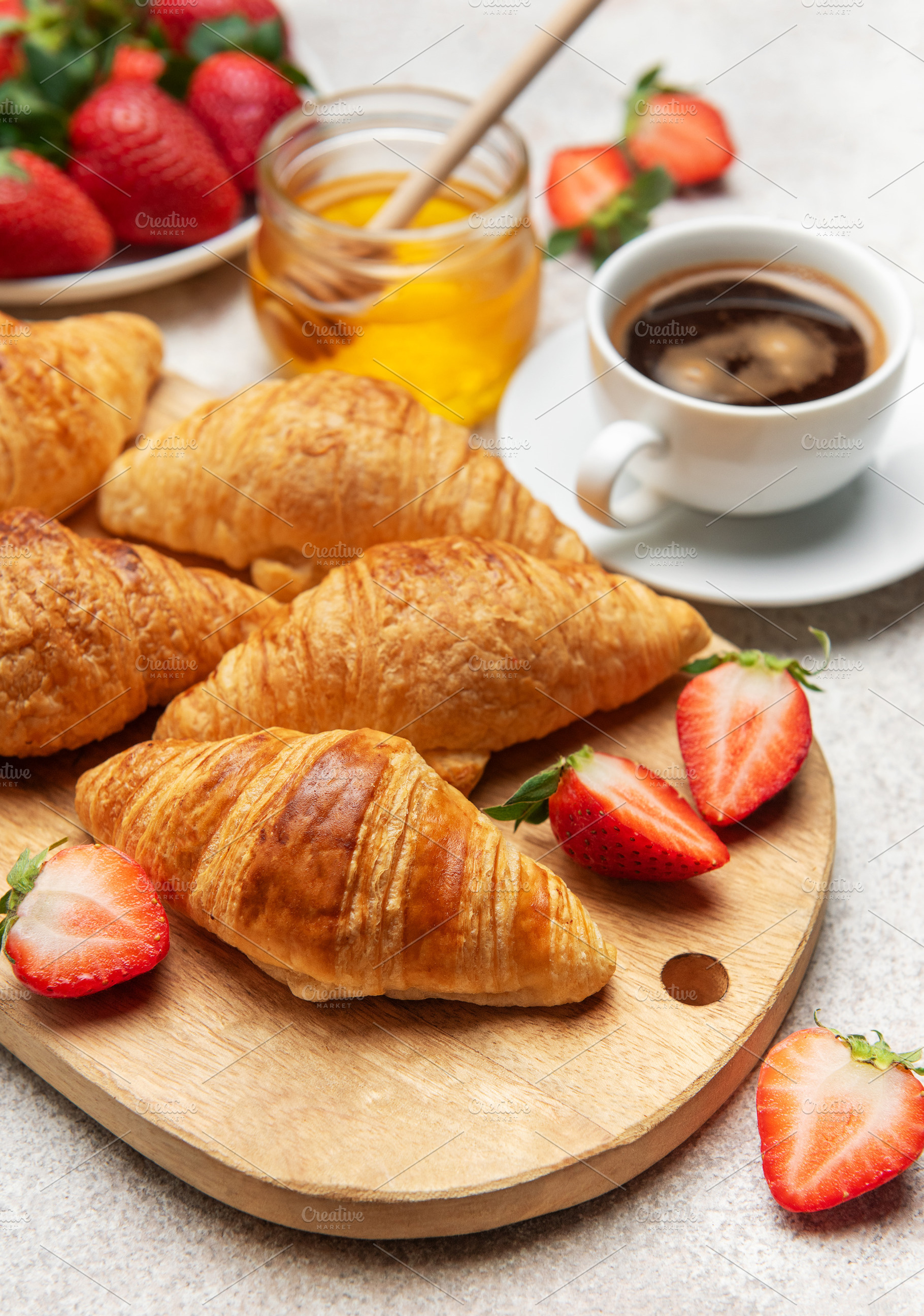 Delicious french breakfast with croissants, coffee, strawberries, a Food & Drink Photo by Olena Rudo