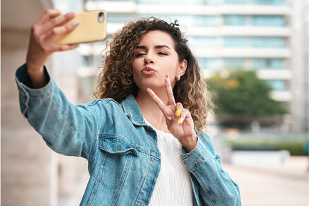 Young woman taking selfies with her, a Person Photo by Mego-studio