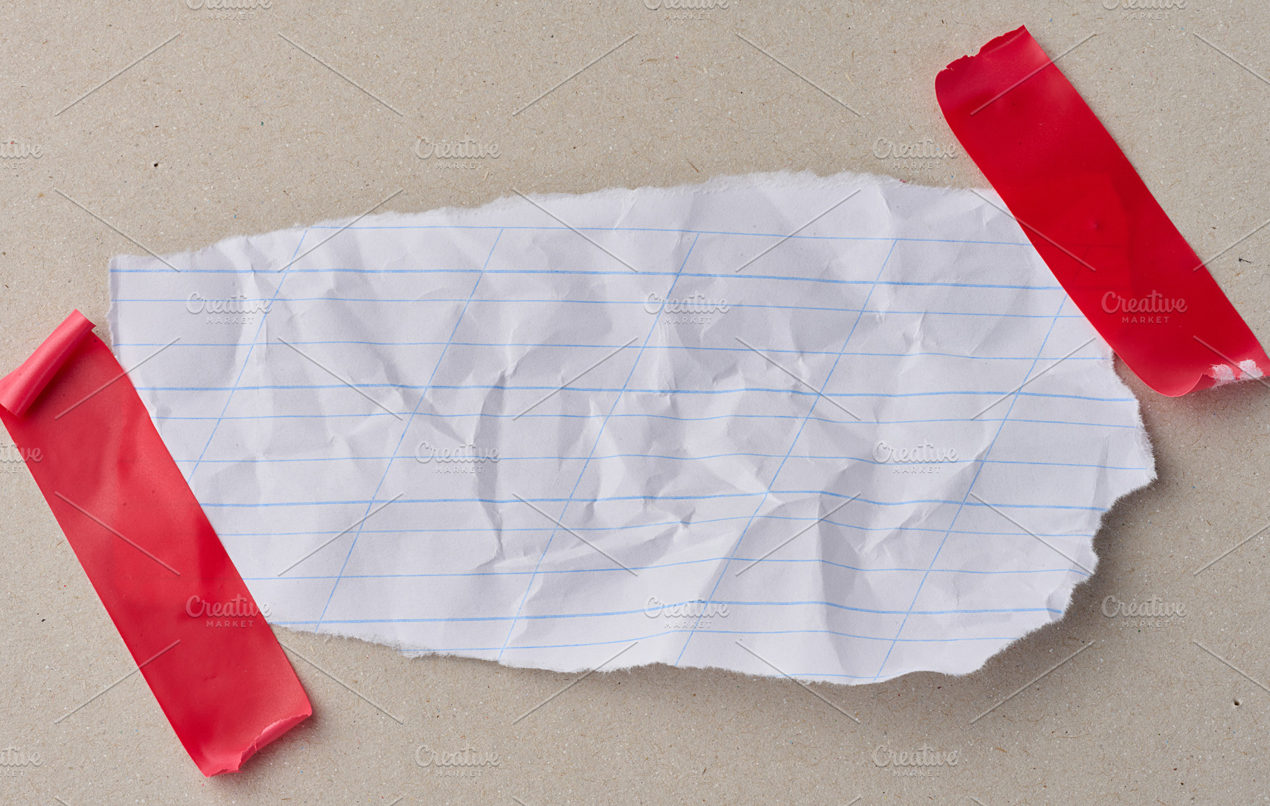 A scrap of white notebook paper with diagonal lines, attached wi, an Abstract Photo by ndanko