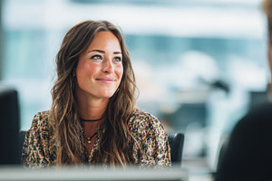 Smiling woman in an office setting, a Photo by Beautiful things