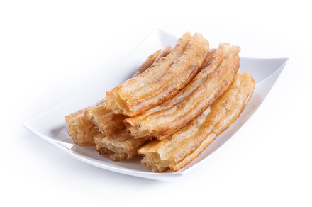 Spanish Churros. Traditional spanish food isolated on white background, a Food & Drink Photo by etorres69