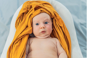 Newborn baby comfortably resting in, a Health & Medical Photo by Elizaveta Galitskaya