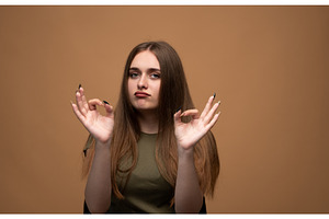 Young woman making okay gesture with, a Person Photo by volodymyrshtun13795
