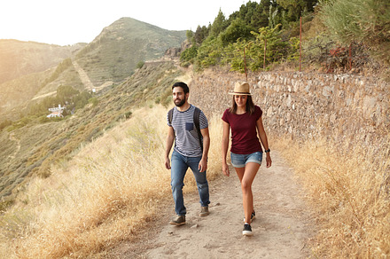 Walking at sunset containing young, couple, and sunlight