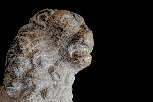 Weathered lion statue against black background, an Arts & Entertainment Photo by DanFLCreativo
