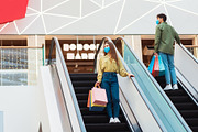 Female And Male Buyers Shopping Standing On Stairs In Mall, a Photo by Prostock-Studio (Thumbnail 1 of 2)
