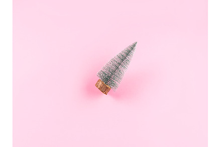 Small toy christmas tree on pink, a Holiday Photo by Lifemorning