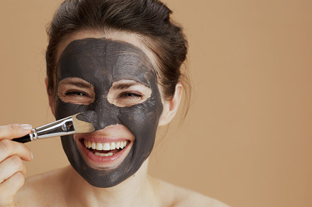Portrait of smiling woman with brush, a Beauty & Fashion Photo by Alliance Images