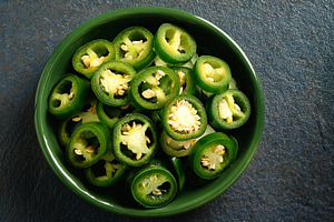 sliced jalapenos vegetarian food AI generated, a Photo by WorldOfPhotos
