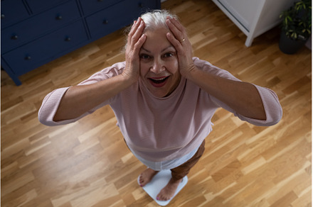 Senior woman stepping on floor, a Health & Medical Photo by Koldunov