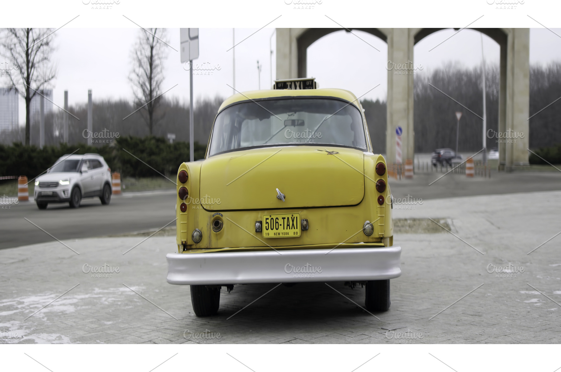A classic yellow taxi parked at a, a Transportation Photo by Media Whale Stock