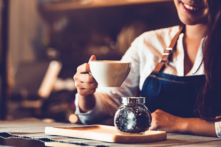 Closeup of professional female barista hand making and holding w, a Person Photo by Ministocker
