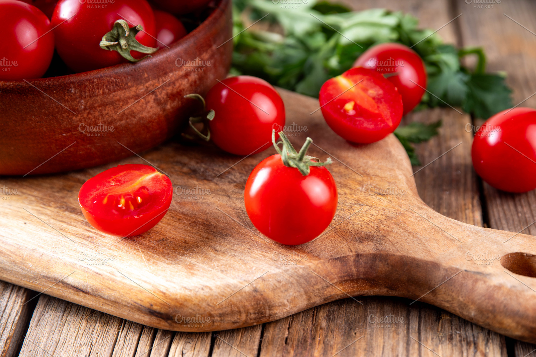 Bowl with tomatoes on wooden background, a Food & Drink Photo by Rimma