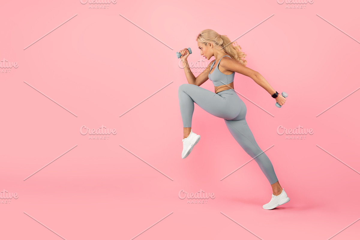 Young Woman Exercising With Dumbbells Isolated On Pastel Background, a Photo by Prostock-Studio (Photo 1 of 2)