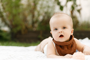 Beautiful happy baby lying on blanket with toys on background of, a Person Photo by Sonjachni