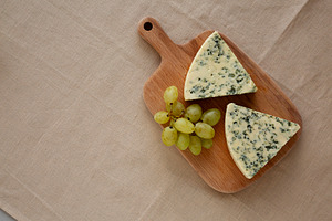 Delicious Cheese Danablu on a wooden board, top view. Copy space, a Food & Drink Photo by LiudmylaChuhunova