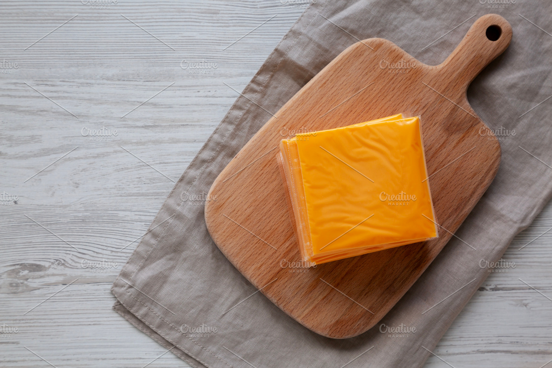 Stack of American Cheese Slices in Wrappers, top view. Copy spac, a Food & Drink Photo by LiudmylaChuhunova