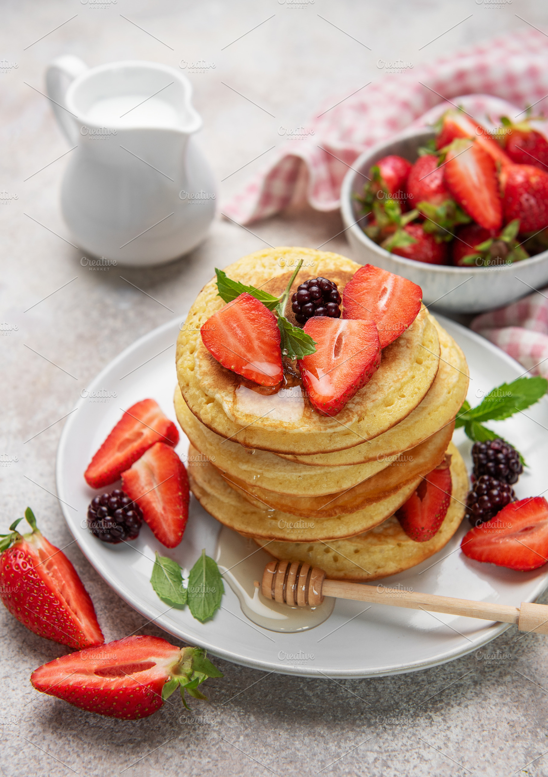 Stack of pancakes with strawberries, blackberries, honey, and mi, a Food & Drink Photo by Olena Rudo