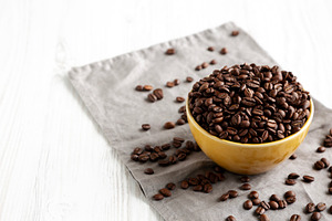 Organic Roasted Coffee Beans in a Bowl, side view. Copy space., a Food & Drink Photo by LiudmylaChuhunova