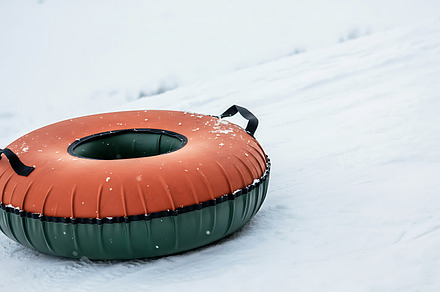 Snow tubing on a snowy hill.