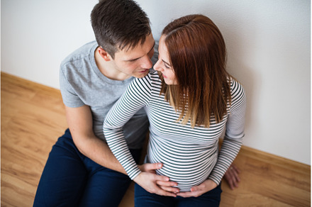 Pregnant woman and her partner, a Person Photo by HalfPoint