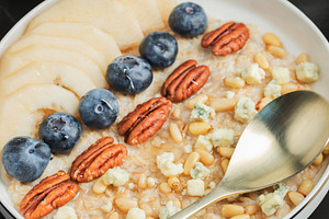 Oatmeal. Bowl of oatmeal porridge with blackberry, bananas and chia seeds on gr