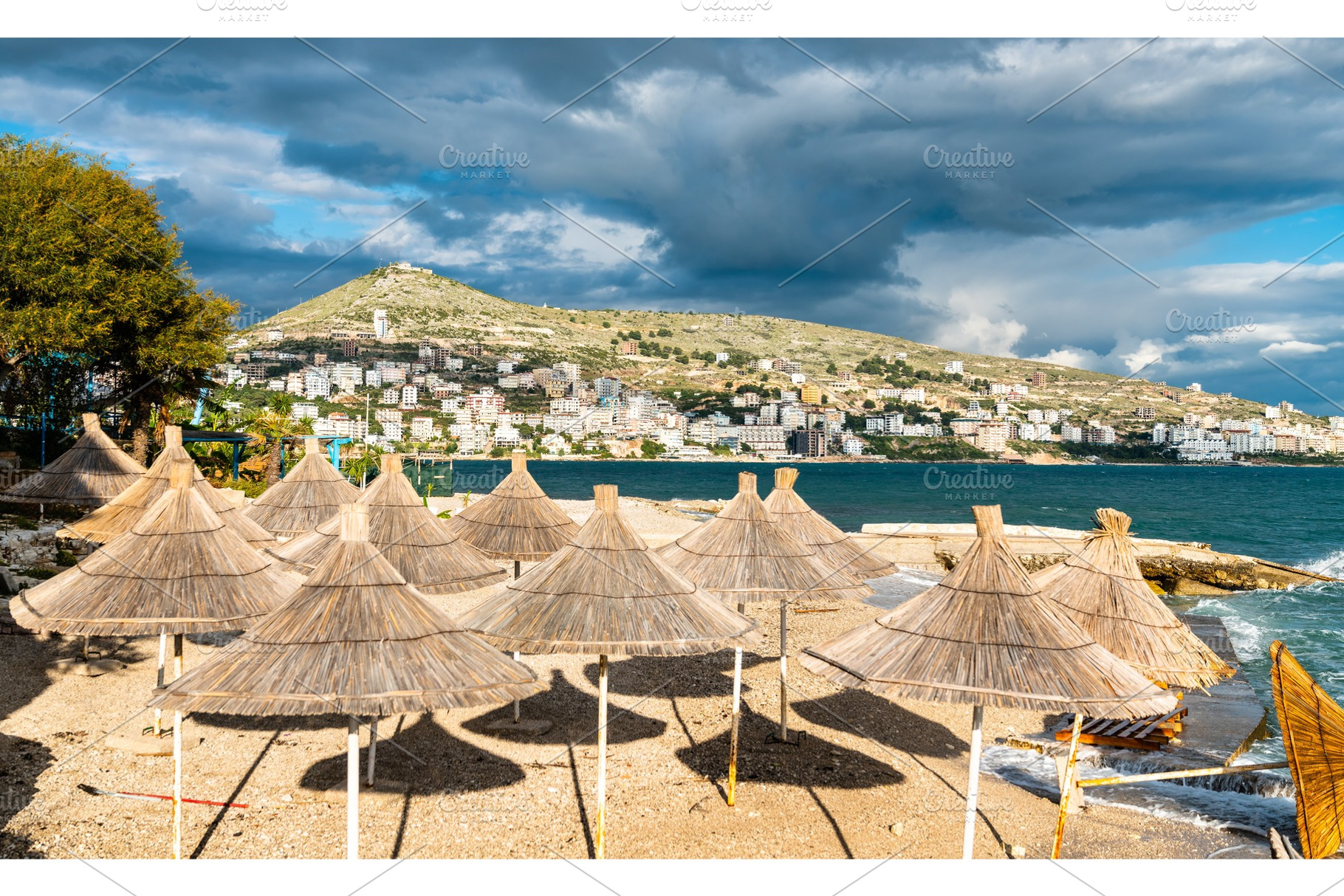 Straw umbrellas on a beach in featuring beach, umbrella, and sunshade, a Nature Photo by Leonid Andronov