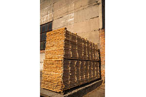 Large stacks with wooden planks in, an Industrial Photo by volodymyrshtun13795