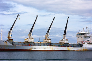 Industrial cargo ship with cranes in, an Industrial Photo by Perpis