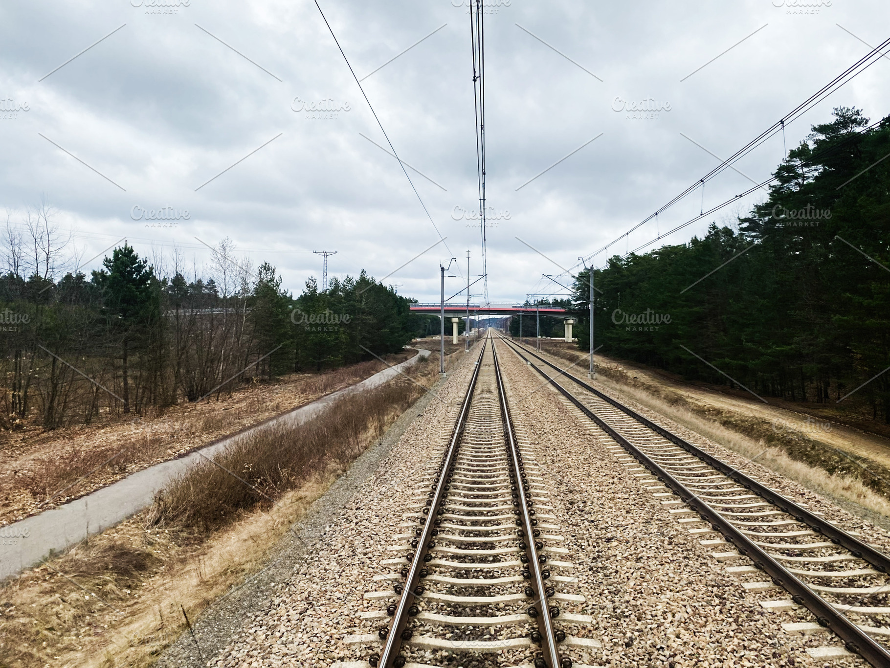 Railway Tracks Amid Nature Near Krakow Poland on a Cloudy Day, a Photo by AS photostudio