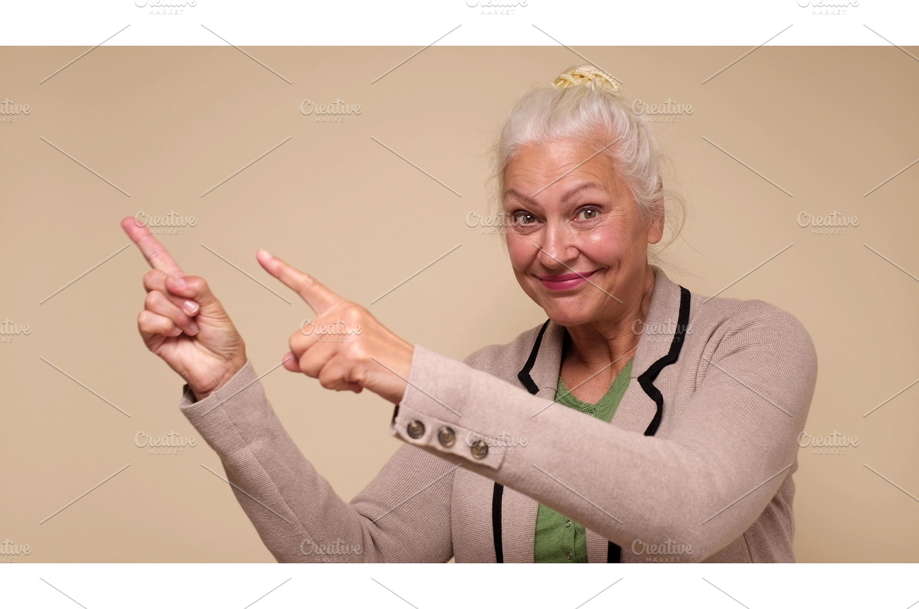 An elderly woman points her finger, a Holiday Photo by Koldunova